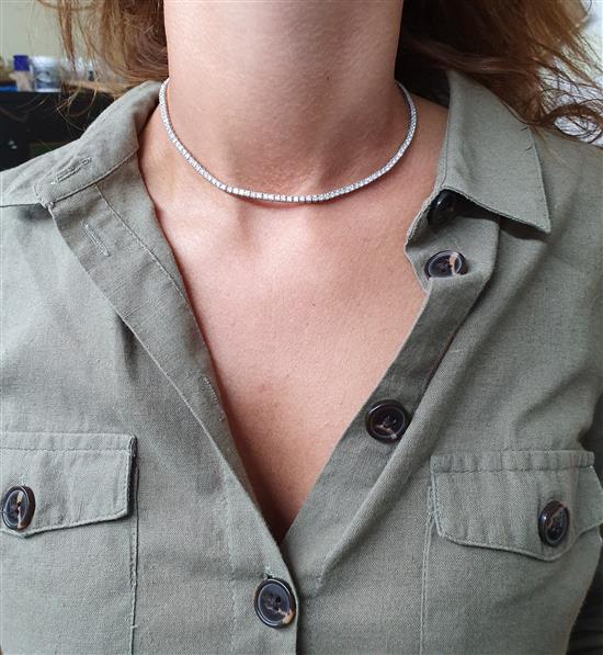 A modern Cartier 18ct white gold and diamond line choker necklace, with Cartier box and certificate dated 14/3/03, 37.5cm.